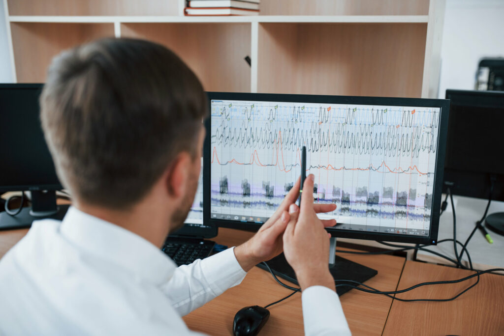 Polygraphist examining polygraph readout on a computer screen