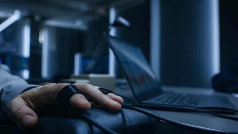 Close-up shot of the suspect's hand connected to the lie polygraph machine.